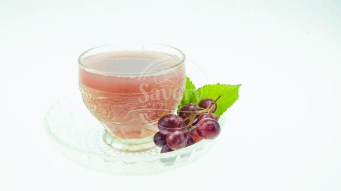 Overhead view of grape juice with fresh grapes